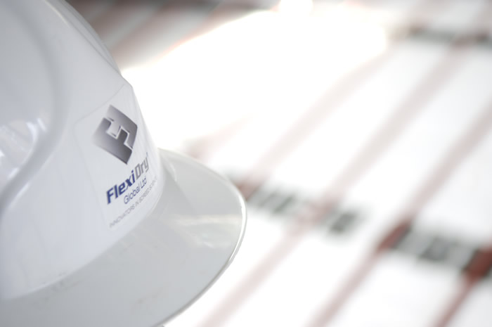 Flexidry logo seen in an image with helmet and underfloor heating